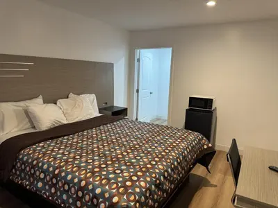 a bedroom with a large bed in a room at Sun Leisure Motel in Menifee