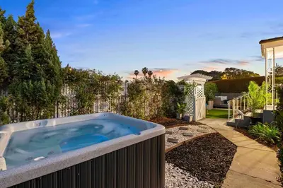 a hot tub in a garden with a fence at PB 3BR Beach Retreat Hot Tub Mini Golf in San Diego