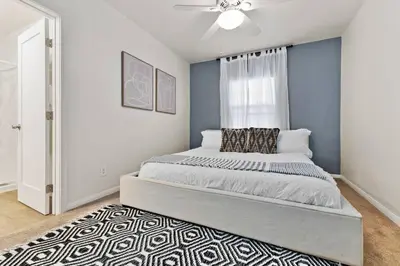 a bedroom with a bed and a ceiling fan at PB 3BR Beach Retreat Hot Tub Mini Golf in San Diego