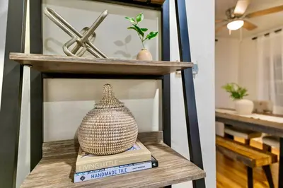 a shelf with a vase sitting on top of books at PB 3BR Beach Retreat Hot Tub Mini Golf in San Diego