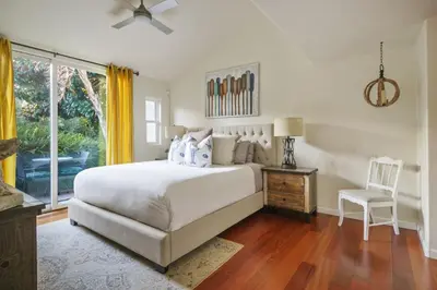 a bedroom with a bed and a chair and a window at Encinitas Paradise | Seabluffe Gated Community w/ Beach Access in Encinitas