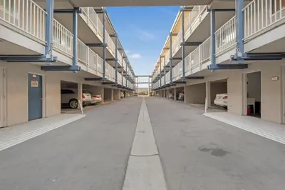 an empty hallway of a building with cars parked at Serene Harborfront Condo | Unbeatable Views & Coastal Charm in Oceanside