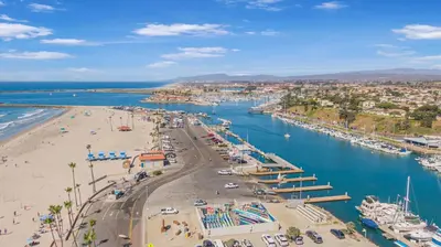 an aerial view of a beach and a harbor at Serene Harborfront Condo | Unbeatable Views & Coastal Charm in Oceanside