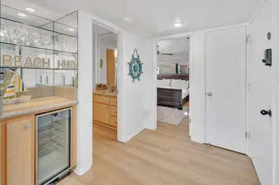 a bathroom with a sink and a room with a bed at Oceanside Harbor Getaway | Steps to Sand, Shops & Restaurants in Oceanside