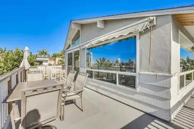 a patio with a table and chairs on a balcony at 3 Mi to Balboa Park Water-View Condo with Balcony in San Diego