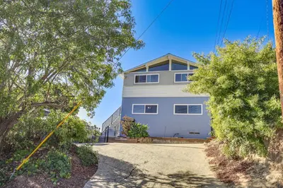 a house with a driveway in front of it at 3 Mi to Balboa Park Water-View Condo with Balcony in San Diego