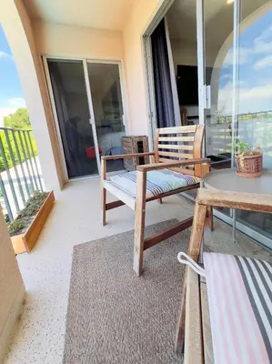 a patio with a table and a bench on a balcony at 2 bed 2 bath penthouse condo with AC and Ocean Views in San Diego