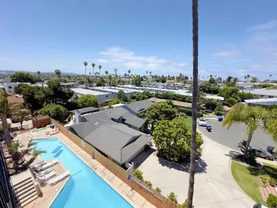an overhead view of a pool at a resort at 2 bed 2 bath penthouse condo with AC and Ocean Views in San Diego