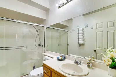 a bathroom with a shower and a sink and a toilet at Water-View Home with Hot Tub in Lake Elsinore! in Lake Elsinore