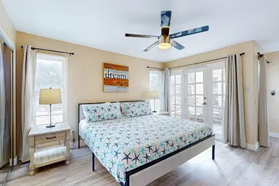 a bedroom with a bed and a ceiling fan at Stroll to Shore and Mission Blvd Dog-Friendly Home in San Diego