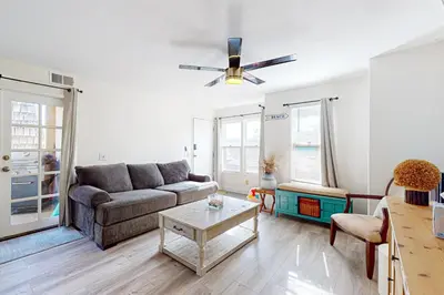 a living room with a couch and a table at Stroll to Shore and Mission Blvd Dog-Friendly Home in San Diego
