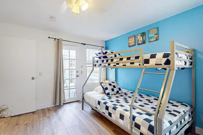 a bedroom with two bunk beds and blue walls at Stroll to Shore and Mission Blvd Dog-Friendly Home in San Diego