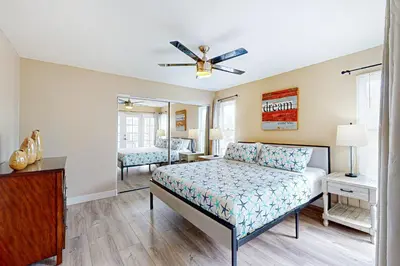 a bedroom with a bed and a mirror at Stroll to Shore and Mission Blvd Dog-Friendly Home in San Diego