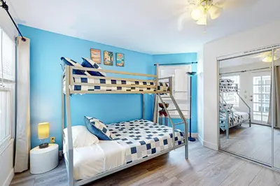 a bedroom with two bunk beds and a blue wall at Stroll to Shore and Mission Blvd Dog-Friendly Home in San Diego