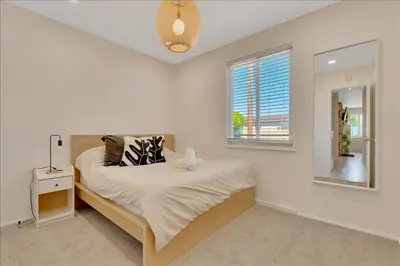 a white bedroom with a bed and a window at Double Flamingo HotTub BBQ Game Room Self Check-in in San Diego