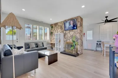 a living room with a couch and a fireplace at Double Flamingo HotTub BBQ Game Room Self Check-in in San Diego