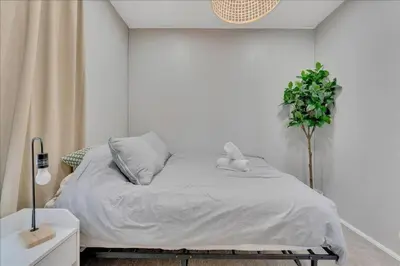 a white bedroom with a bed with a stuffed animal on it at Double Flamingo HotTub BBQ Game Room Self Check-in in San Diego