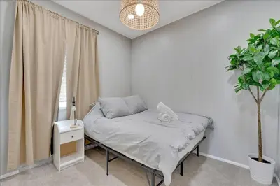 a bedroom with a bed and a potted plant at Double Flamingo HotTub BBQ Game Room Self Check-in in San Diego