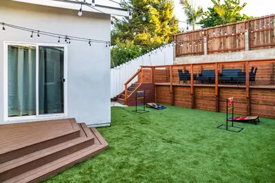 a small backyard with a yard with green grass at Newly Built Coastal Home with Yard in San Diego