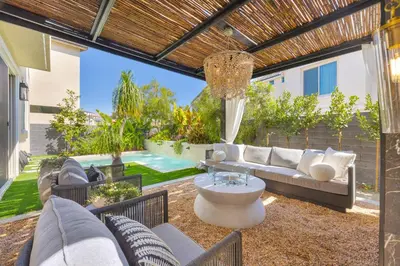 a patio with a couch and chairs and a chandelier at # Marbella Lane - Stylish Dream Home in RMV with Pool in Mission Viejo