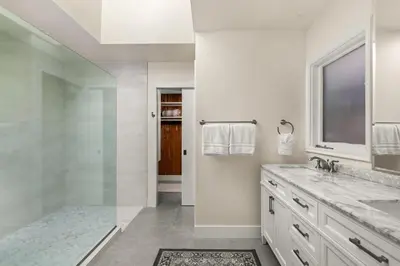 a bathroom with a shower and a sink and a mirror at Pacific Perfection - Ocean Views Jacuzzi Walk to Beach and Dining in San Diego