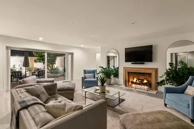 a living room with a couch and a fireplace at Pacific Perfection - Ocean Views Jacuzzi Walk to Beach and Dining in San Diego