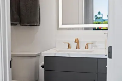 a white bathroom with a sink and a toilet at Stylish 2 Bedroom King Bed EVCharger Pet-Friendly Balcony in San Diego