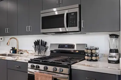 a kitchen with a stove and a microwave at Stylish 2 Bedroom King Bed EVCharger Pet-Friendly Balcony in San Diego