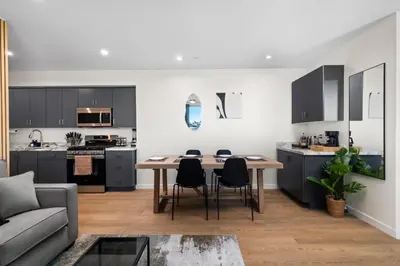 a kitchen and living room with a table and chairs at Stylish 2 Bedroom King Bed EVCharger Pet-Friendly Balcony in San Diego