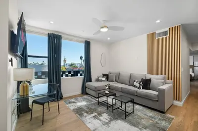 a living room with a couch and a large window at Stylish 2 Bedroom King Bed EVCharger Pet-Friendly Balcony in San Diego