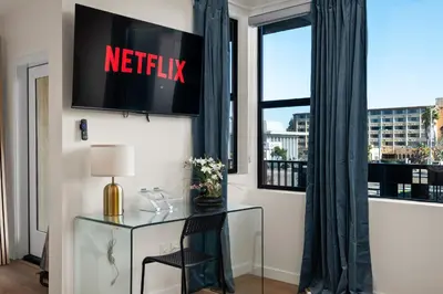 a desk in a room with a netflix sign on a window at Stylish 2 Bedroom King Bed EVCharger Pet-Friendly Balcony in San Diego