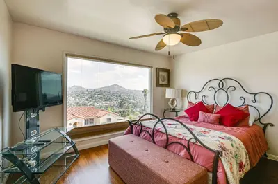 a bedroom with a bed and a large window at Amazing Views with massive pool Total Oasis in La Mesa