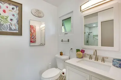 a white bathroom with a toilet and a sink at Amazing Views with massive pool Total Oasis in La Mesa