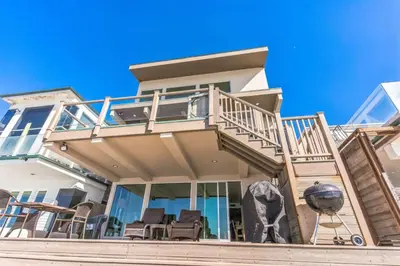 a house with a balcony with chairs on the stairs at Massive 5 bedroom overlooking the water-STR14-0105 in Dana Point