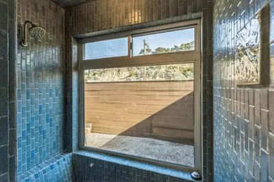 a bathroom with a window and a shower with blue tiles at Massive 5 bedroom overlooking the water-STR14-0105 in Dana Point