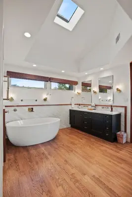 a bathroom with a large white tub and a sink at Village Vistas - Walk to Beach and LJ Village, AC, Spa in San Diego