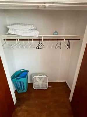 a closet with a shelf with hangers and a basket at Boho Chic Loft Little Italy Walk Everywhere in San Diego