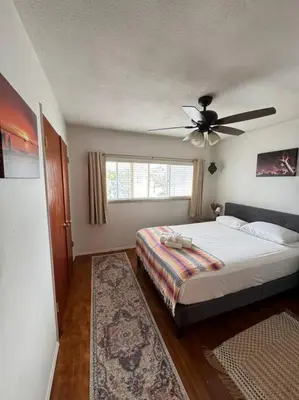a bedroom with a bed and a ceiling fan at Boho Chic Loft Little Italy Walk Everywhere in San Diego