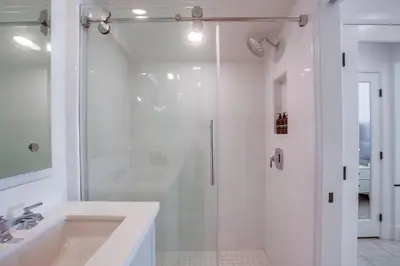 a white bathroom with a shower and a sink at Bayside Cove 8 in San Diego