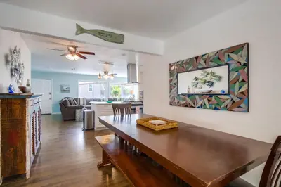 a dining room with a table and a living room at Tidal Wave 2 WINTER SPECIAL! in San Diego