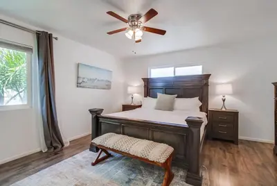 a bedroom with a bed and a ceiling fan at Tidal Wave 2 WINTER SPECIAL! in San Diego