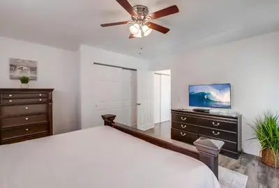 a bedroom with a bed and a ceiling fan at Tidal Wave 2 WINTER SPECIAL! in San Diego