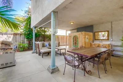 an outdoor patio with a wooden table and chairs at Tidal Wave 2 WINTER SPECIAL! in San Diego
