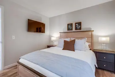 a bedroom with a large bed and two lamps at Local Gem 1 in San Diego