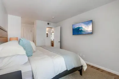 a bedroom with two beds and a painting on the wall at Local Gem 1 in San Diego