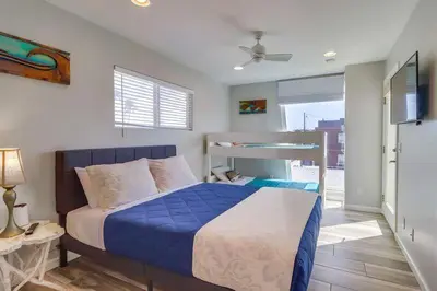 a bedroom with a bed with a blue comforter at Ocean & Bay in San Diego