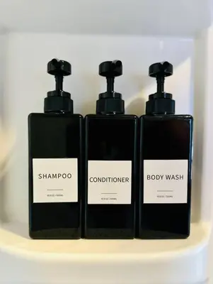 three bottles of soap sitting on a shelf at 3-Bedroom, Prime Location, Private Backyard! in San Diego