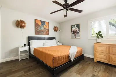 a bedroom with a bed and a ceiling fan at Leucadia Beach House - 4 Mins to Moonlight! in Encinitas