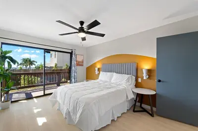 a bedroom with a bed and a ceiling fan at Stylish & Bright 5 Star Location Ocean View Queen Beds in San Diego