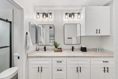 a white bathroom with two sinks and two mirrors at Good Vibes Cottage - Carlsbad-Vista-San Diego-Beach-Legoland in Vista
